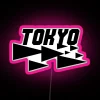 A vibrant pink Tokyo cityscape with a neon sign in the foreground.