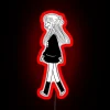 Woman walking under a vibrant, neon-lit sign at night