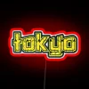 Neon sign reflecting in Tokyo's streets at night with vibrant RGB colors.