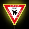 Neon sign in a danger zone with a Tomcat F-14 logo, featuring vibrant colors and bold typography.