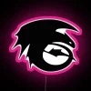 Neon sign silhouette of a toothless dragon in pink RGB lighting