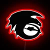 Neon sign of a dragon silhouette, specifically Toothless from How to Train Your Dragon, with bold red colors against a dar...