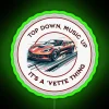 Corvette neon sign with RGB lights illuminating the iconic Vette logo at night.