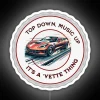 Neon-lit Corvette logo on top of a car or building at night with vibrant RGB colors.