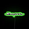 Neon-lit Toyota Supra GR logo on a green background.