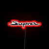 Neon sign with red Toyota Supra logo in bold, futuristic design.