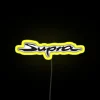 Neon Toyota Supra logo sign with bright yellow background.