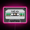 Colorful neon trail mix sign with pink accents on a dark background.