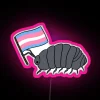 A rainbow-colored pill bug under a neon pink sign with a transgender flag in the background.