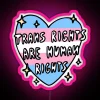 Rainbow neon sign with bold, colorful letters reading 'Trans Rights Are Human Rights'.
