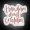 Neon sign with bold, colorful letters reading 'Transform Don't Conform'