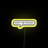 Neon sign with bright yellow letters reading 'Trust the Process'