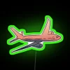 Neon travel sign with green letters in a colorful cityscape at night.