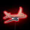 Neon travel sign in red color against a dark background.