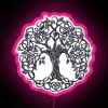 Neon sign featuring a stylized silver tree of life design with vibrant RGB colors and pink accents.