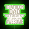 Triathlon dad with neon sign, balancing parenting and athletic achievements