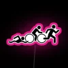 Neon triathlon sign with pink, blue, and green colors in bold, futuristic font.