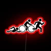 Neon triathlon sign with colorful lights and bold typography.