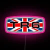 Triumph TR6 badge with Union flag neon sign in pink