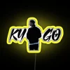 Vibrant neon sign of a tropical house with yellow hues.