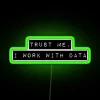 Neon sign with glowing green letters reading 'Trust me, I work with data'
