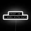 Neon sign with bold, white letters reading 'Trust Me, I Work With Data'