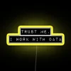 Neon sign with glowing letters that read 'Trust me, I work with data' in yellow.