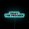 Neon sign reading 'Trust The Process'