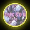 Tucson cactus neon sign illuminated at night with pink and yellow hues