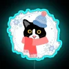 Tuxedo cat in winter attire posing next to an RGB neon sign.