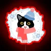 Tuxedo cat dressed in winter attire, surrounded by neon lights.