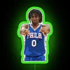 Philadelphia 76ers point guard Tyrese Maxey under a colorful neon sign
