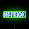 Neon LED sign reading 'Unc Beat Dook Led' in green letters, resembling an outdoor advertisement.