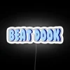 LED neon sign reading 'UNC Beat Doak Led' in bold white letters on a dark background.