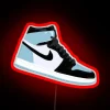 Neon-lit UNC Jordan 1 sign with red LEDs and pin accents.