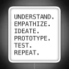 Design thinking process steps with RGB neon signs illustrating understand, empathize, ideate, prototype, test, repeat.