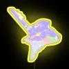 Neon RGB sign with yellow hues in an urban setting.