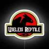 A vibrant, RGB-lit neon sign reading 'Useless Reptile' in bold white letters.