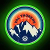 Neon sign in Val Thorens, France's vibrant ski area with a green glow at night.