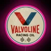Neon Valvoline racing sign with pink and RGB colors on a dark background.
