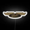 Velocette motorcycle logo with neon accents on a white background