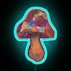 Neon-colored, glowing mushroom in vibrant blue hues under a city sign at night.