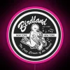 Vintage neon sign reading 'Birdland Jazz Club' in pastel pink hue.