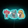 Vocaloid triple baka chibi figurines displayed on a colorful RGB neon sign in blue hues.