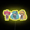 Vocaloid Triple Baka Chibi characters with RGB neon colors on a yellow background in front of a city street sign.