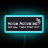 Voice-controlled LED light illuminating a paper towel dispenser with a neon blue glow.