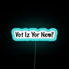 Neon sign reading 'VOT-IZ-YOR-NEM' in blue RGB color scheme.