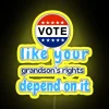 Neon sign with bold, colorful letters encouraging people to vote for their future.