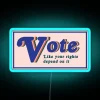 Colorful neon sign reading 'Vote like your rights depend on it'