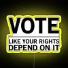 Neon sign with bold, colorful letters reading 'Vote Like Your Rights Depend On It'